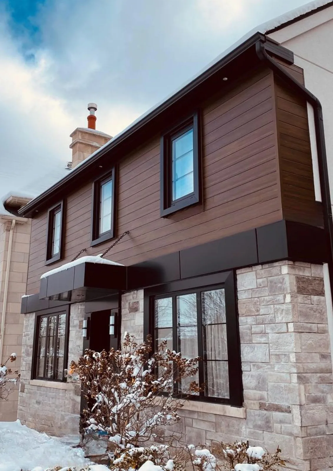 Dark brown wood grain aluminum siding on residential home exterior